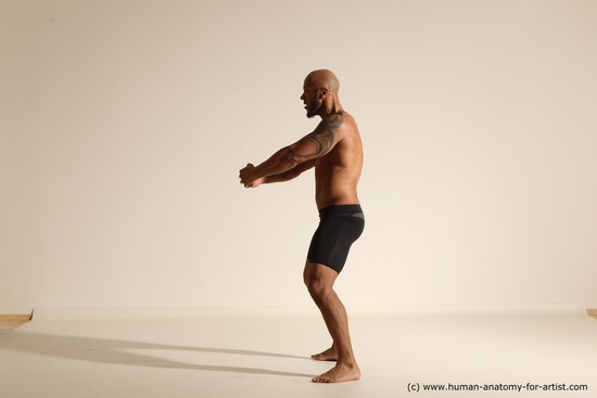 Underwear Gymnastic poses Man Black Muscular Bald Dancing Dynamic poses Academic