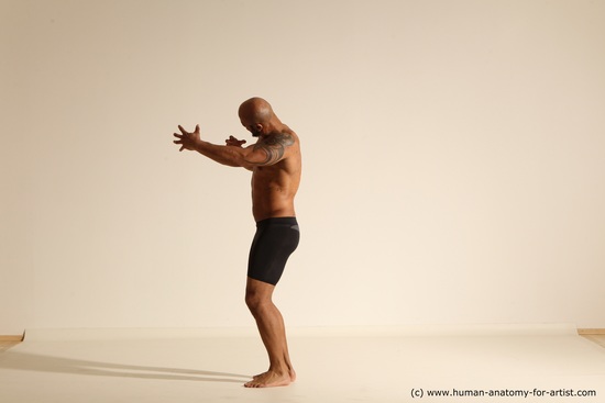 Underwear Gymnastic poses Man Black Muscular Bald Dancing Dynamic poses Academic