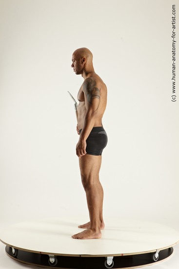 Underwear Fighting with spear Man Black Sitting poses - simple Muscular Bald Sitting poses - ALL Multi angles poses Academic