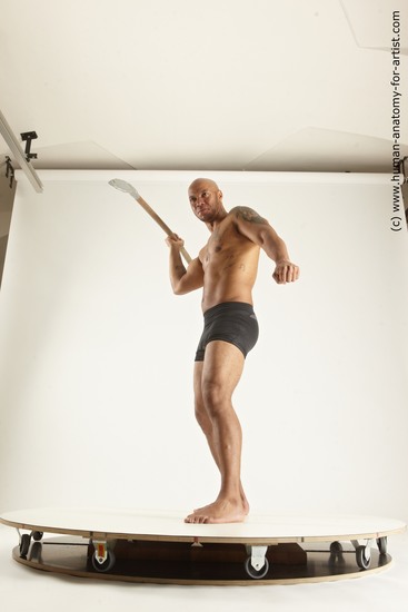 Underwear Fighting with spear Man Black Sitting poses - simple Muscular Bald Sitting poses - ALL Multi angles poses Academic