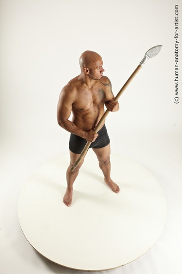 Underwear Fighting with spear Man Black Sitting poses - simple Muscular Bald Sitting poses - ALL Multi angles poses Academic