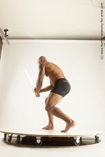 Underwear Fighting with sword Man Black Muscular Bald Multi angles poses Academic