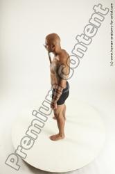 Underwear Fighting with spear Man Black Sitting poses - simple Muscular Bald Sitting poses - ALL Multi angles poses Academic