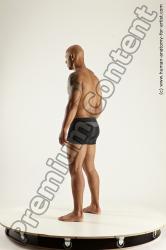 Underwear Fighting with spear Man Black Sitting poses - simple Muscular Bald Sitting poses - ALL Multi angles poses Academic