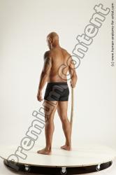 Underwear Fighting with spear Man Black Sitting poses - simple Muscular Bald Sitting poses - ALL Multi angles poses Academic