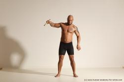 Sportswear Man Black Muscular Bald Dynamic poses Academic